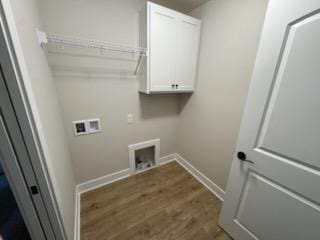laundry area featuring washer hookup, baseboards, cabinet space, and dark wood finished floors