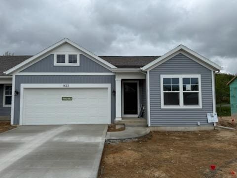 single story home with a garage and concrete driveway