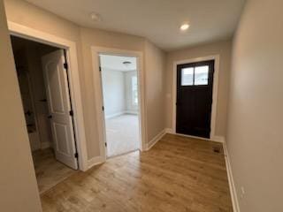 entryway with wood finished floors, baseboards, and recessed lighting
