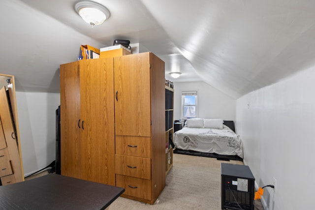 bedroom with vaulted ceiling and light carpet