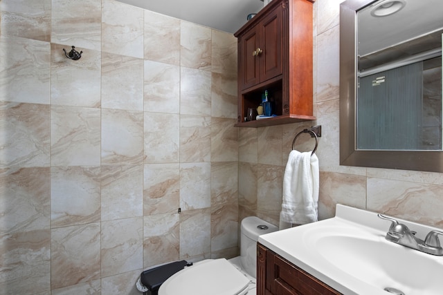 bathroom with tile walls, backsplash, vanity, and toilet