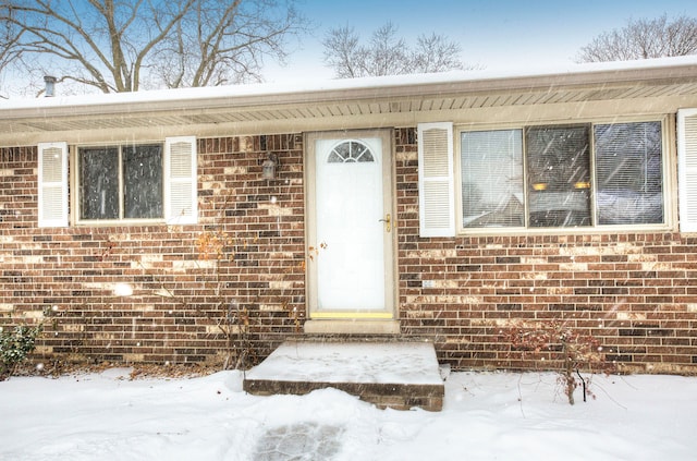 view of snow covered property entrance