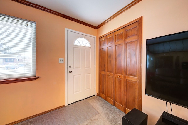 carpeted entryway with ornamental molding