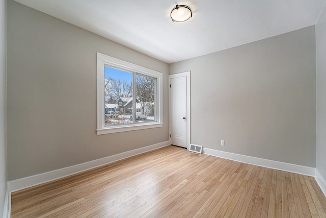 spare room featuring light wood-type flooring