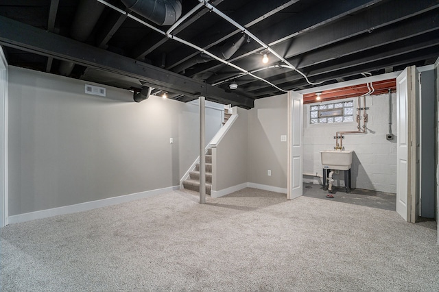 basement with sink and carpet flooring