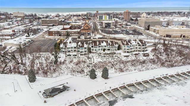 snowy aerial view featuring a water view