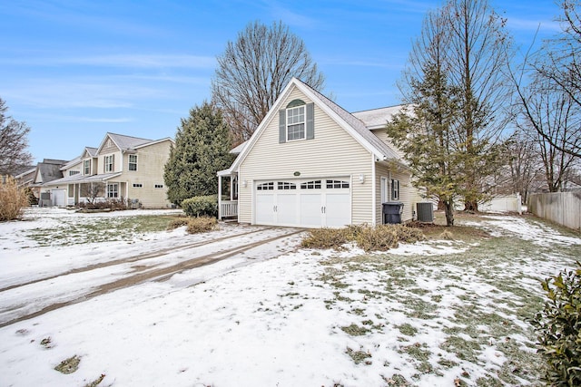 snow covered property featuring central AC