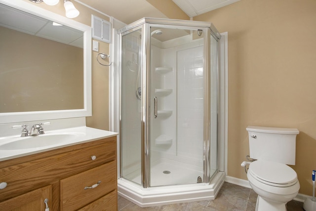 bathroom featuring tile patterned floors, vanity, a shower with shower door, and toilet