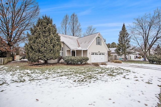 snow covered property with a garage