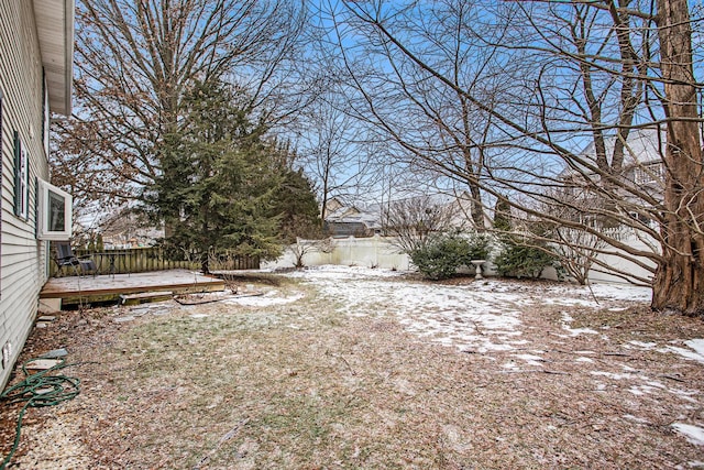 snowy yard with a wooden deck