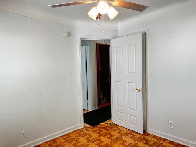 unfurnished room featuring parquet flooring and ceiling fan