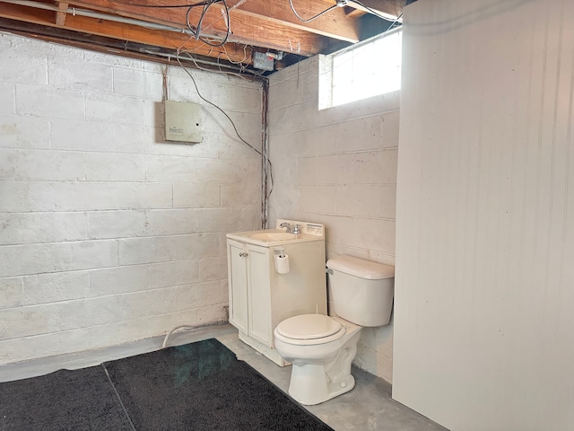 bathroom featuring concrete flooring, sink, and toilet