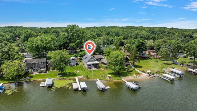 drone / aerial view featuring a water view and a wooded view