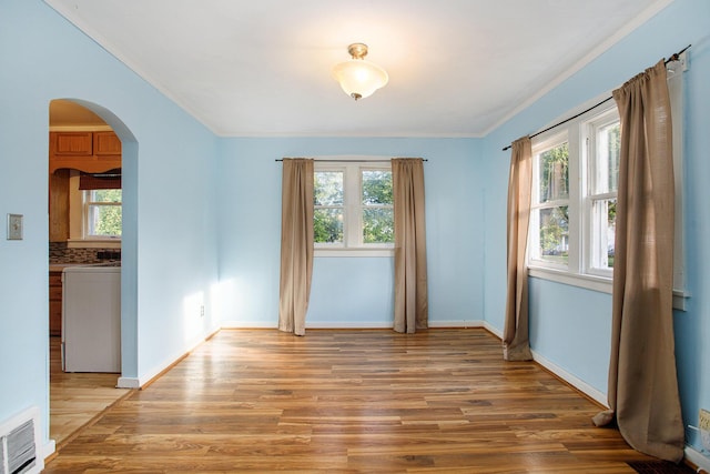 spare room featuring ornamental molding and hardwood / wood-style floors