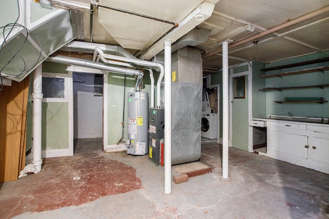 basement featuring gas water heater, heating unit, and washer / clothes dryer