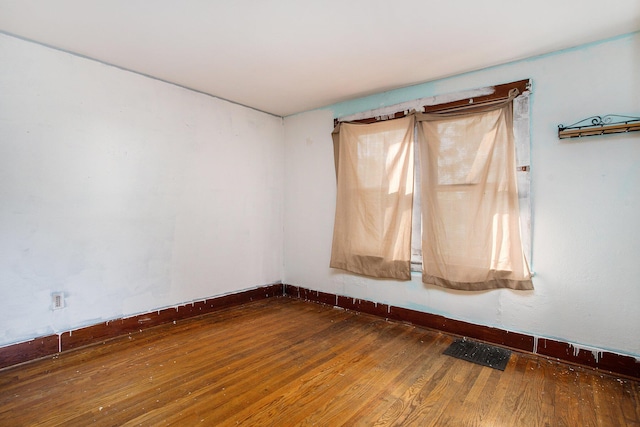 empty room featuring dark wood-type flooring