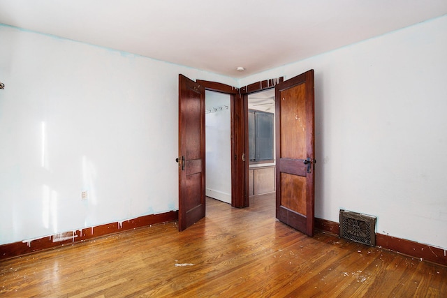 unfurnished room with hardwood / wood-style floors