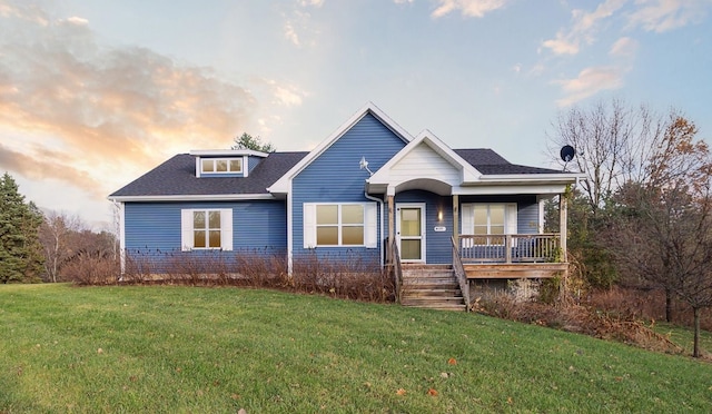 view of front of house with a yard and a porch