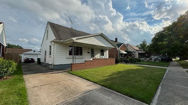 bungalow featuring a front yard, a garage, and a porch