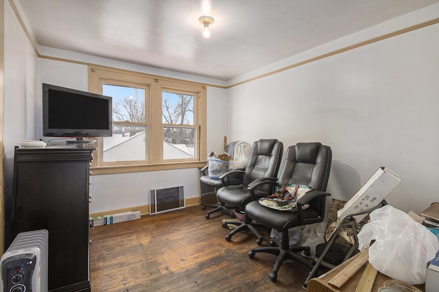 office space featuring radiator heating unit and dark hardwood / wood-style flooring