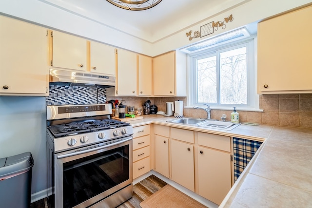 kitchen with sink, backsplash, and stainless steel range with gas stovetop