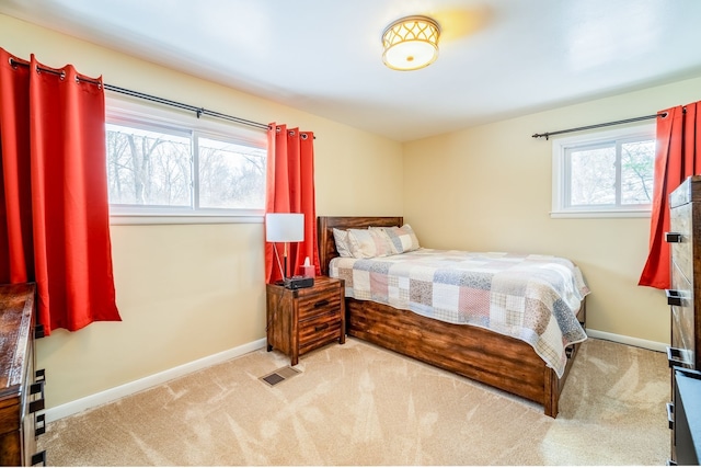 bedroom featuring light colored carpet