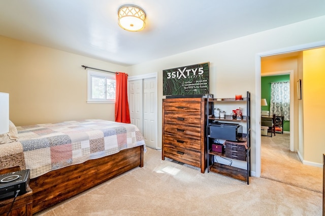 bedroom with light carpet and a closet