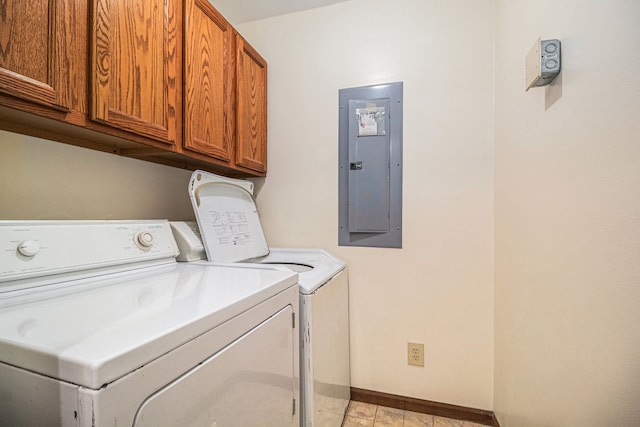 laundry area with washer and clothes dryer, cabinet space, electric panel, and baseboards