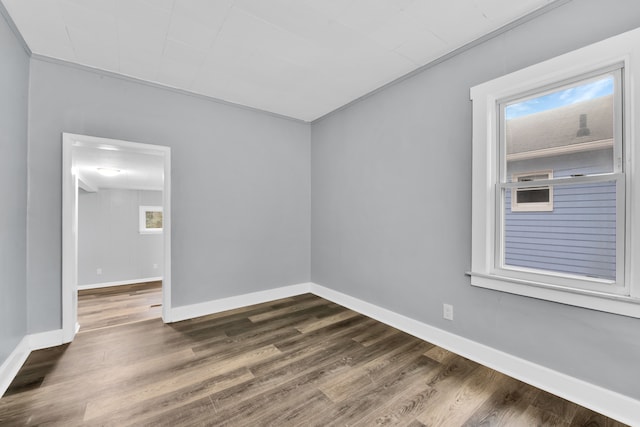 unfurnished room featuring dark wood-style floors and baseboards