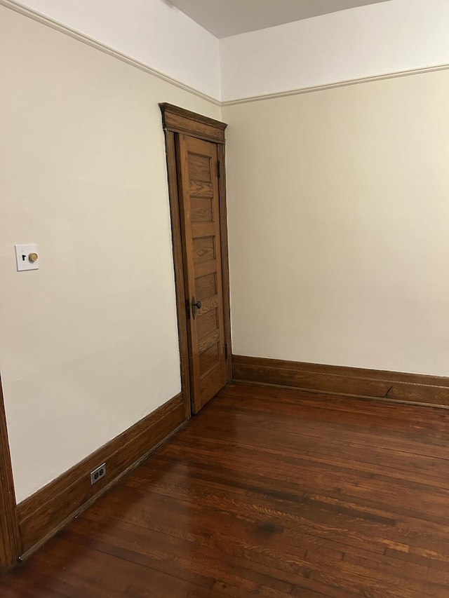 empty room with dark hardwood / wood-style floors