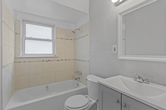 full bathroom with tiled shower / bath combo, vanity, and toilet