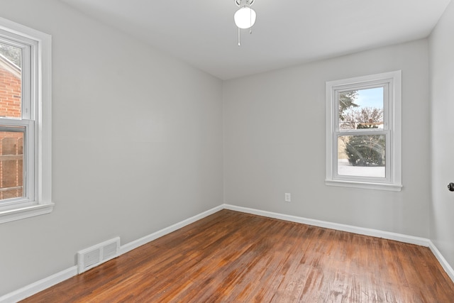 unfurnished room with dark wood-type flooring