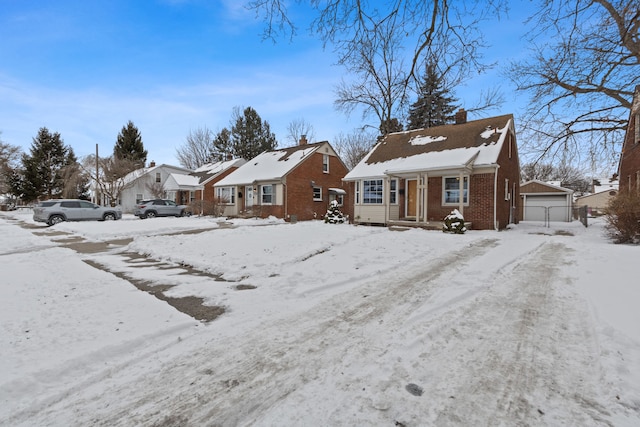 view of front of house with a garage and an outdoor structure