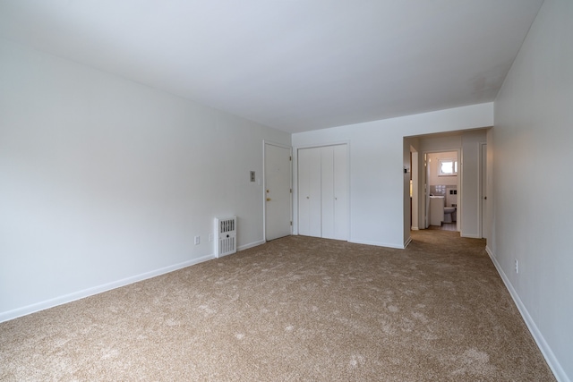 unfurnished bedroom with a closet, carpet, and baseboards