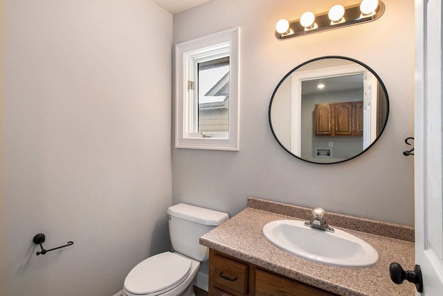 bathroom with toilet and vanity