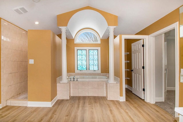 bathroom with ornate columns, shower with separate bathtub, and wood-type flooring