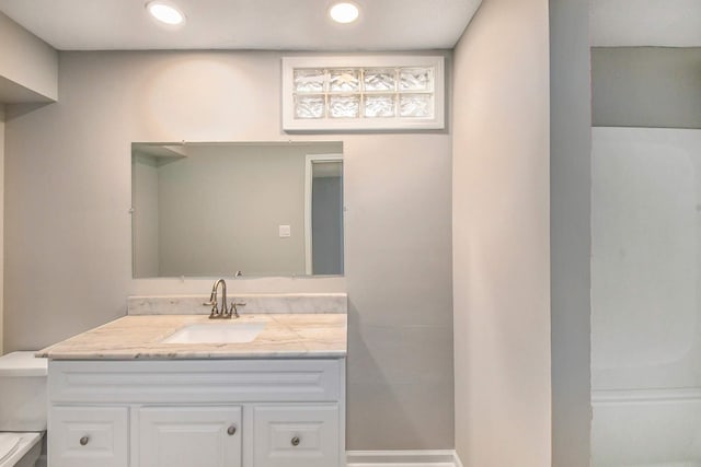 bathroom featuring vanity and toilet