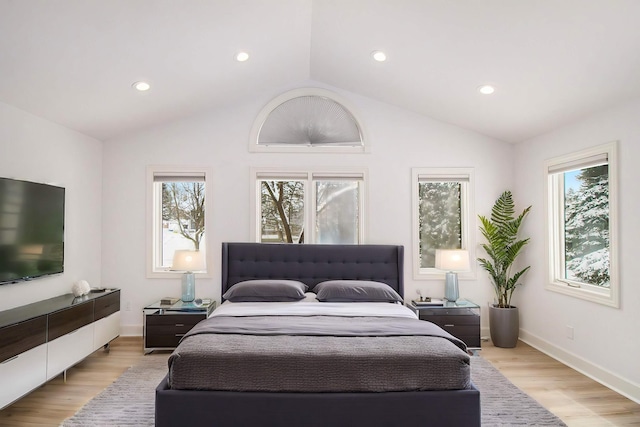 bedroom featuring light hardwood / wood-style floors and vaulted ceiling