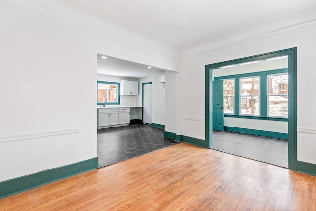 unfurnished room with sink and dark hardwood / wood-style floors