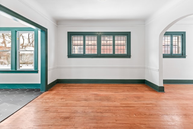 empty room featuring hardwood / wood-style flooring and crown molding