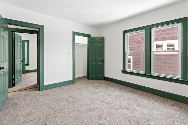 unfurnished bedroom featuring a closet and carpet flooring