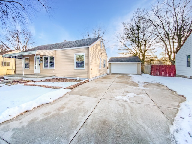 view of front of home with covered porch, a garage, and an outdoor structure