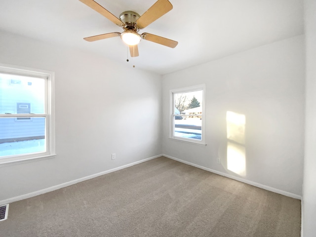 spare room featuring ceiling fan and carpet flooring