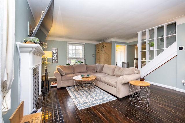 living room featuring dark hardwood / wood-style flooring and ornamental molding