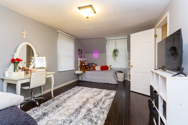 bedroom with dark hardwood / wood-style floors