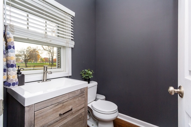 bathroom featuring vanity and toilet