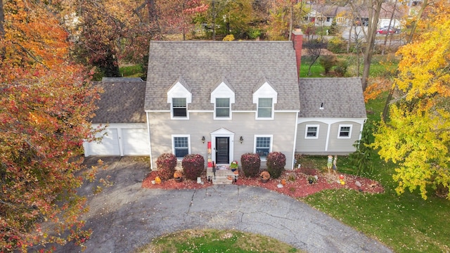 view of front of home with a front yard and a garage