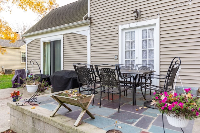 view of patio featuring grilling area, cooling unit, and french doors