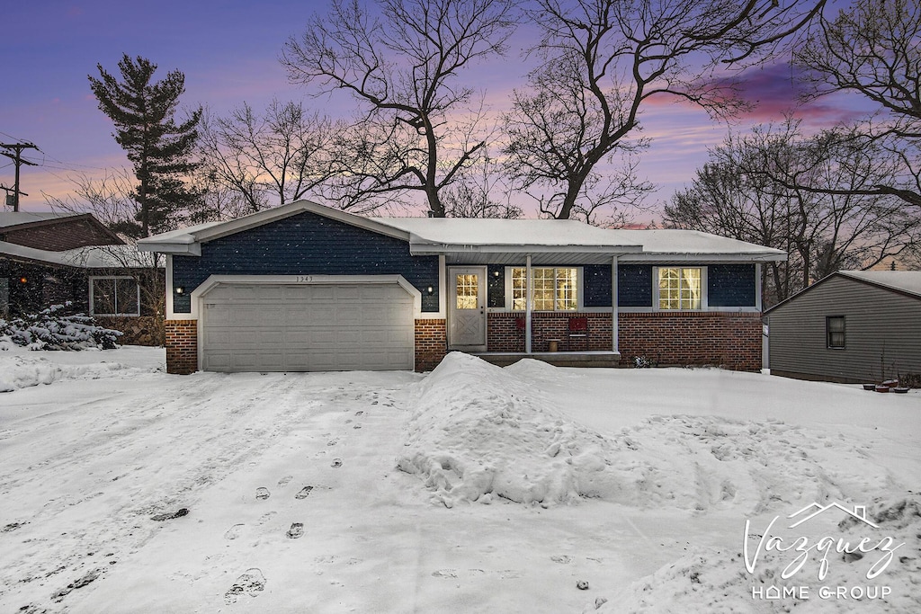 ranch-style home featuring a garage