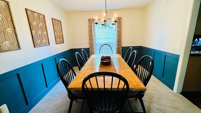 dining room with a notable chandelier and light carpet